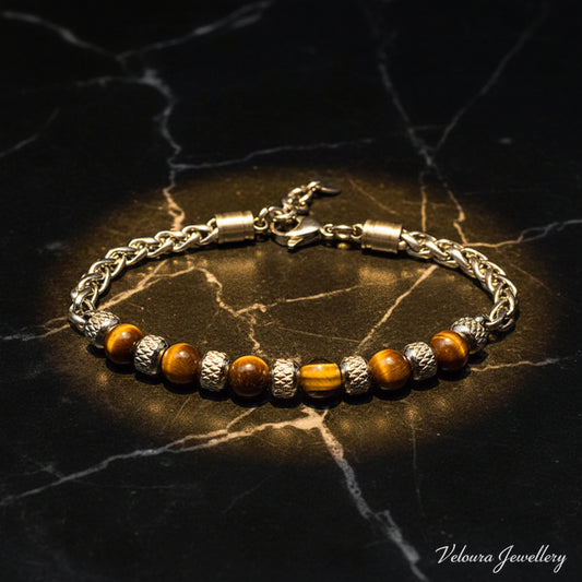 Bracelet with brown beads and silver chain on a dark background